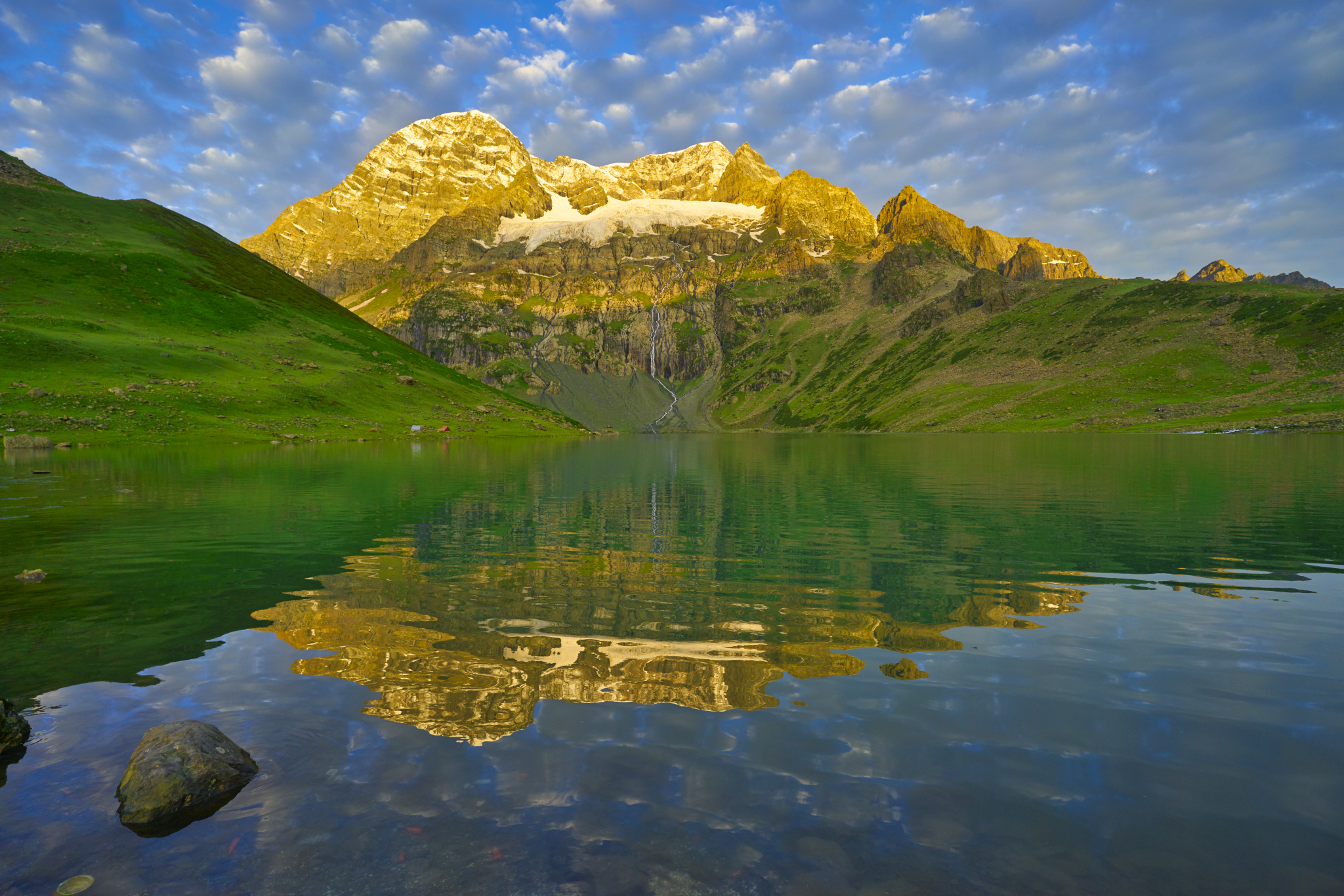 Golden light falling across Harmukh's face